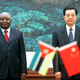 Mozambique's former president Armando Guebuza (L) stands next to China's former leader Hu Jintao during a signing ceremony at the Great Hall of the People in Beijing.